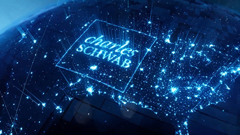 Schwab logo lit up across a map of the United States