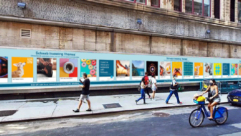 people walking and on bicycles looking at Schwab augmented reality posters