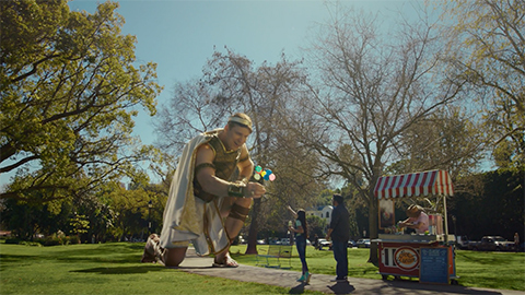 Titan handing balloons to person in a park