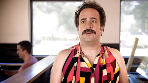 Man wearing dress and earrings