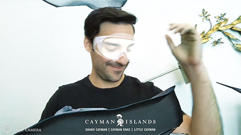 Man in scuba goggles surrounded by sea life