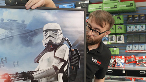 GameStop employee holding Star Wars poster