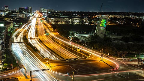 Choctaw ad projected onto Leaning Tower of Dallas next to a highway