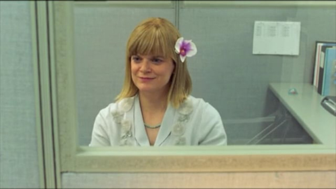 Woman in office with flower in her hair