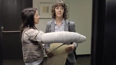 Woman with cast on her arm blocking elevator door