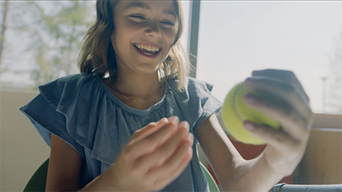 Girl holding tennis ball