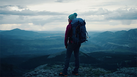 Woman on top of a mountain looking at the view
