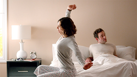 Couple waking up in bed