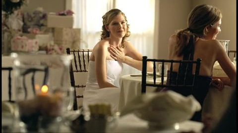 Bride sitting at table with other guests