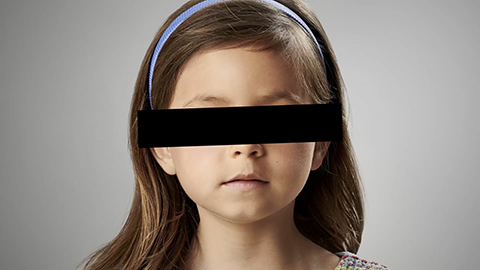 little girl with eyes covered