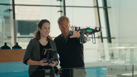 Man and woman flying a drone