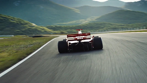 race car driving on road
