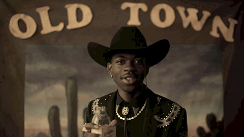 Lil Nas X dressed as cowboy with the words Old Town at top of the image