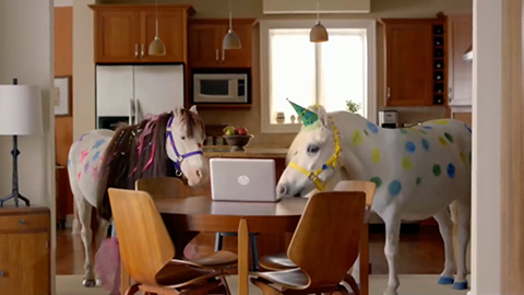 Ponies with sparkles looking at a laptop