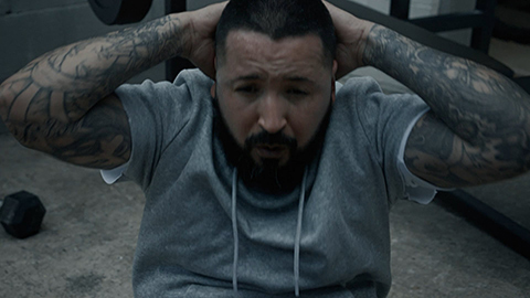 man with tattoos doing sit ups