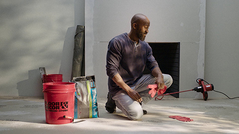 man working on floor with tools