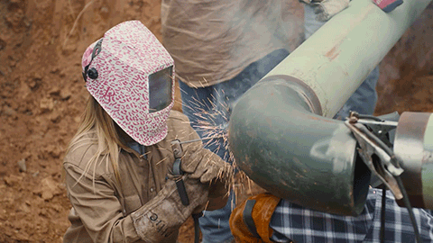 woman welding pipe