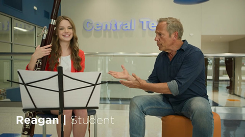 girl playing instrument with man