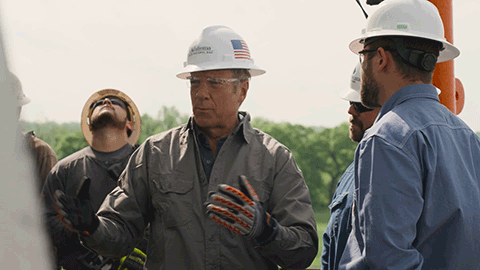 men in hard hats talking
